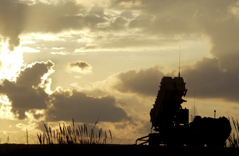 A Patriot anti-missile system deployed in a joint U.S. and Israeli military outpost in Jaffa, south of Tel Aviv is silhouetted against the setting sun (photo credit: NIR ELIAS / REUTERS)