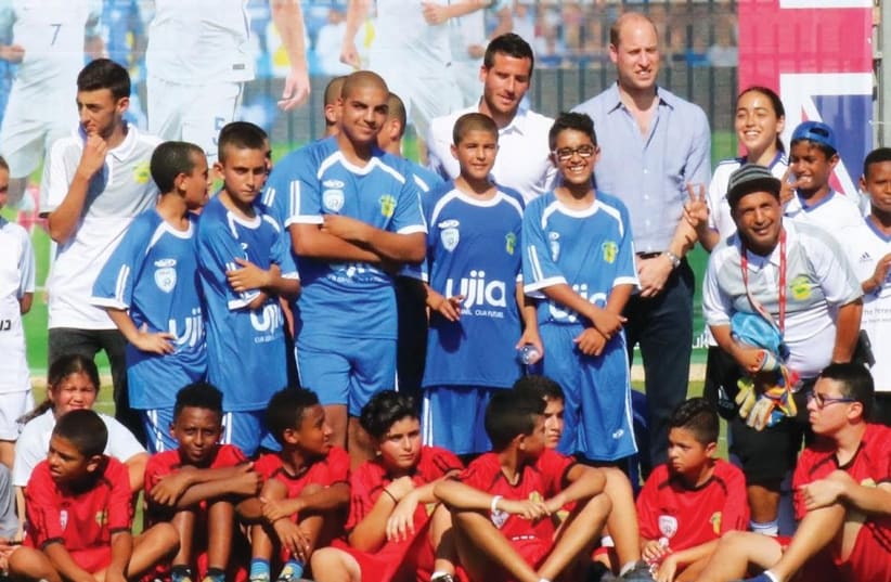 PRINCE WILLIAM poses with participants of The Equalizer program yesterday in Jaffa after their exhibition soccer game.  (photo credit: AVIV HAVRON)