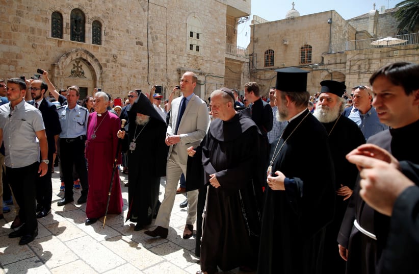 Britain's Prince William walks with religious leaders as he arrives for a visit to the Church of the Holy Sepulchre in Jerusalem's Old City, June 28, 2018 (photo credit: REUTERS/AMMAR AWAD)