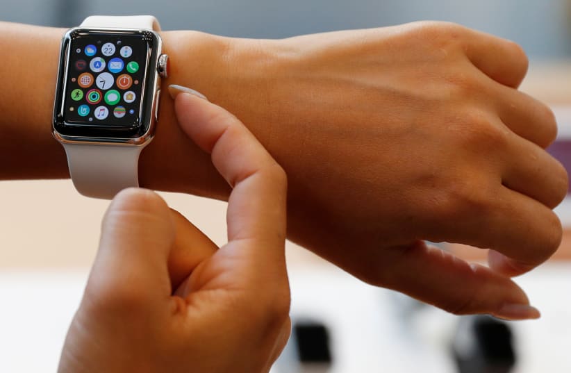 A woman tries a new Apple Watch (photo credit: REUTERS/ISSEI KATO)