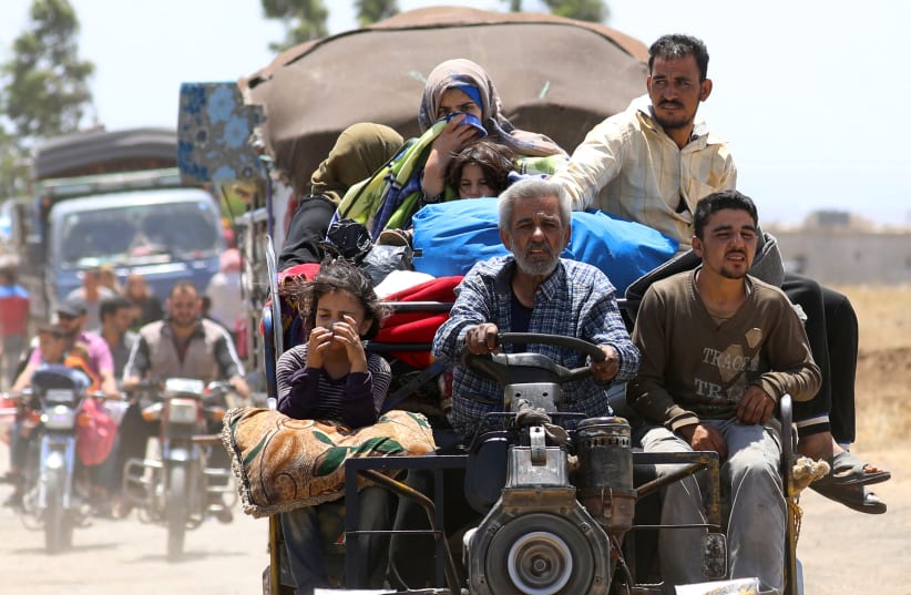 Internally displaced people from Deraa province arrive near the Golan Heights in Quneitra, Syria June 29, 2018. (photo credit: REUTERS/ALAA AL-FAQIR)