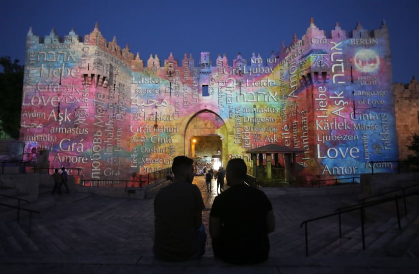 Damascus Gate, which leads to Jerusalem’s Old City, is projected with the word 'love' in different languages in honor of the capital’s 10th annual International Festival of Light, 2018 (photo credit: MARC ISRAEL SELLEM)