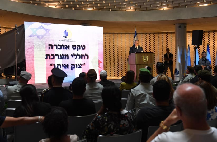 Prime Minister Benjamin Netanyahu speaks at a ceremony marking Operation Protective Edge, July 3, 2018 (photo credit: HAIM ZACH/GPO)