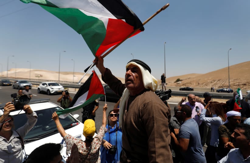 Palestinians attend a protest against Israel's plans to demolish the Bedouin village of Khan al-Ahmar, in the West Bank July 6, 2018. (photo credit: MOHAMAD TOROKMAN/REUTERS)