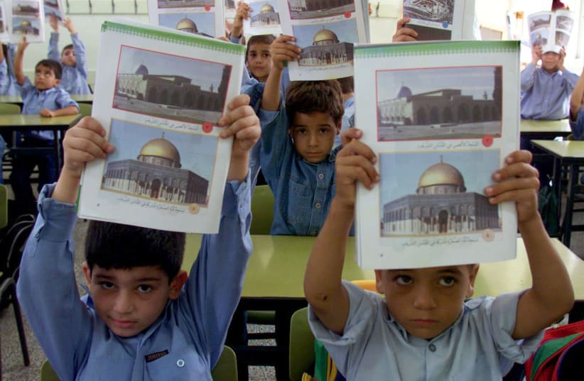 Palestinian students display their new Palestinian educational syllabus at the beginning of his new school year in Gaza Strip September 7, 2000 (photo credit: REUTERS)