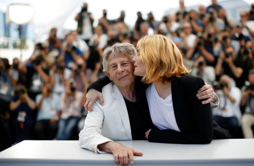 Emmanuelle Seigner kisses Director Roman Polanski at a photocall for the film "Based on a True Story" at the 70th Cannes Film Festival (photo credit: REUTERS/STEPHANE MAHE)