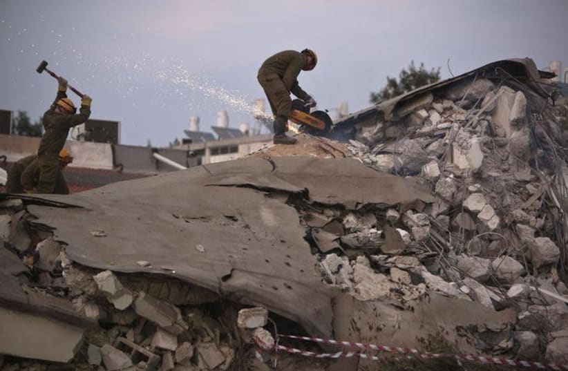 Israeli soldiers from the Home Front Command stand on rubble as they take part in an earthquake drill in Holon, near Tel Aviv October 21, 2012 (photo credit: REUTERS/NIR ELIAS)