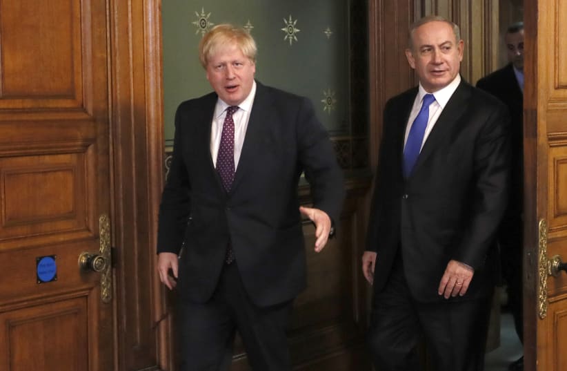 Britain's Foreign Secretary Boris Johnson (L) greets Israel's Prime Minister Benjamin Netanyahu at the Foreign Office in London, February 6, 2017 (photo credit: REUTERS/KIRSTY WIGGLESWORTH/POOL)