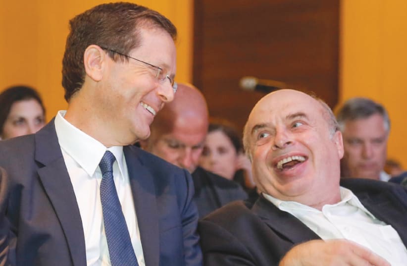 Isaac Herzog shares a laugh with Natan Sharansky following Herzog’s election as chairman of the Jewish Agency at the Board of Governors meeting in Jerusalem on June 24, 2018 (photo credit: NIR KAFRI/JAF)