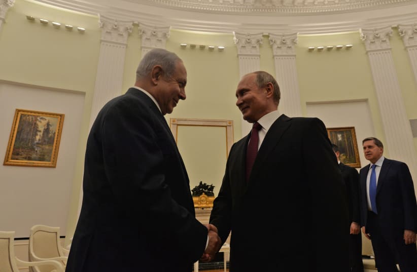 Prime Minister Benjamin Netanyahu shakes hands with Russian President Vladimir Putin  (photo credit: KOBI GIDEON/GPO)