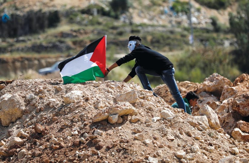 A Palestinian demonstrator protesting on ‘Nakba Day'  (photo credit: REUTERS)