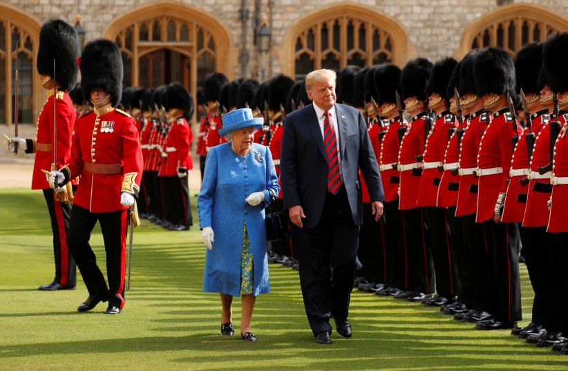 U.S. President Donald Trump and Britain's Queen Elizabeth inspect the Coldstream Guards during a visit to Windsor Castle (photo credit: KEVIN LAMARQUE/REUTERS)