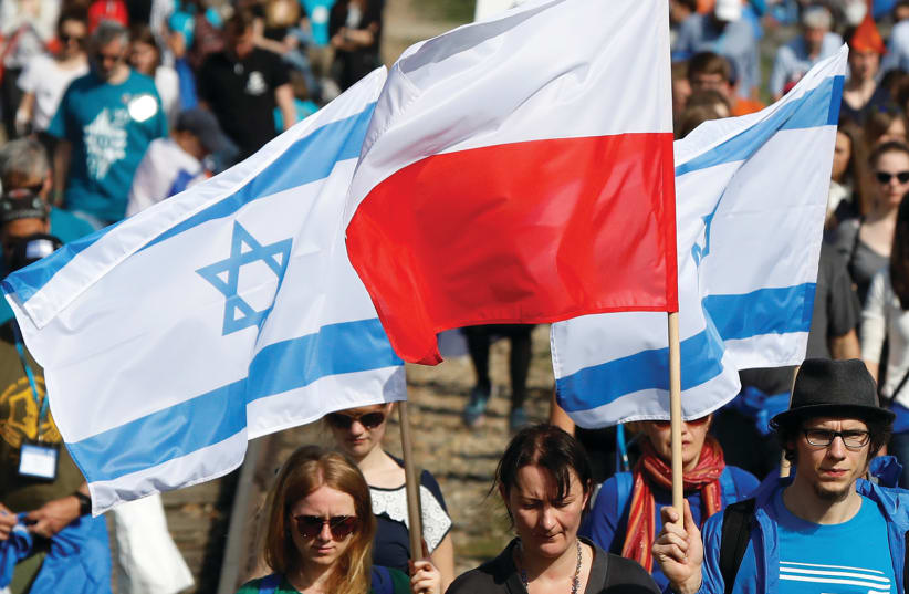 Polish and Israeli flags at a march next to Auschwitz in April (photo credit: REUTERS)