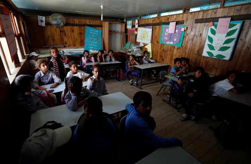Palestinian children attend class at school that began in 2018 in Khan al-Ahmar that will be demolished in the West Bank (photo credit: REUTERS/MOHAMAD TOROKMAN)