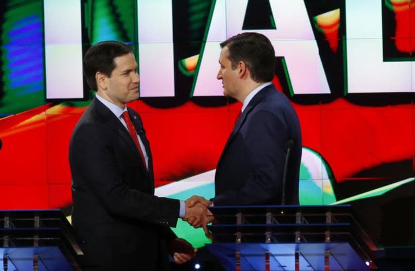 Marco Rubio (L) and Ted Cruz (R) shake hands (photo credit: REUTERS/MIKE STONE)