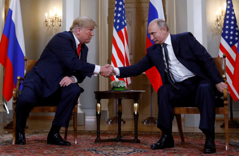 U.S. President Donald Trump and Russia's President Vladimir Putin shake hands as they meet in Helsinki, Finland July 16, 2018 (photo credit: REUTERS/KEVIN LAMARQUE)