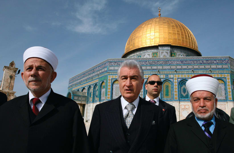 MUFTI OF JERUSALEM Mohammed Hussein (right) walks in front of the Dome of the Rock in 2007 (photo credit: AMMAR AWAD / REUTERS)