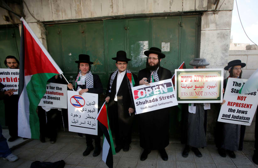 Members of Neturei Karta, a fringe ultra-Orthodox movement within the anti-Zionist bloc, attend a protest in solidarity with Palestinians in Hebron in February. (photo credit: MUSSA QAWASMA / REUTERS)