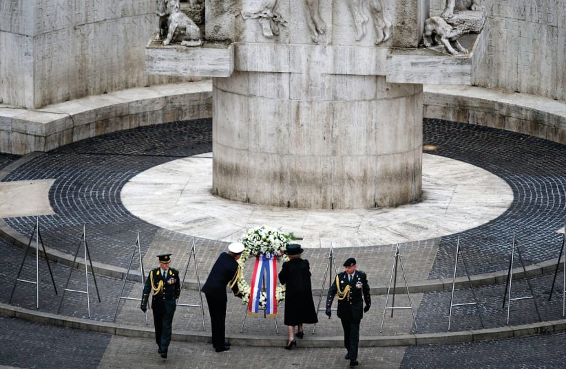 Dutch Queen Beatrix and Prince Willem-Alexander lay a garland to commemorate those who lost their lives during World War II, at the National Monument at Dam Square in Amsterdam (photo credit: REUTERS)