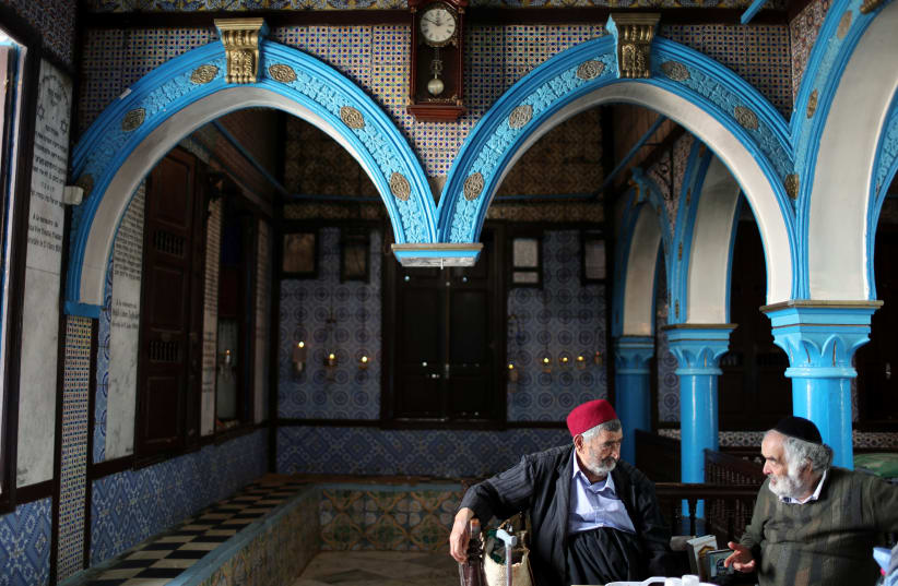 Two Tunisian Jewish men are seen at Ghriba, the oldest Jewish synagogue in Africa, Tunisia, 2018 (photo credit: AHMED JADALLAH / REUTERS)