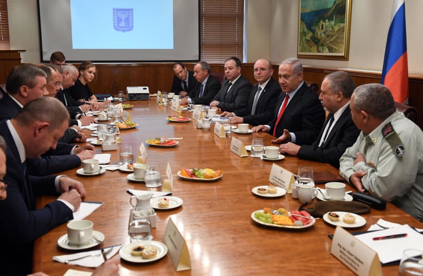 Prime Minister Benjamin Netanyahu (C-R), Defense Minister Avigdor Liberman and IDF Chief of Staff Gadi Eizenkot discuss regional developments with Russian officials, July 23, 2018 (photo credit: HAIM ZACH/GPO)