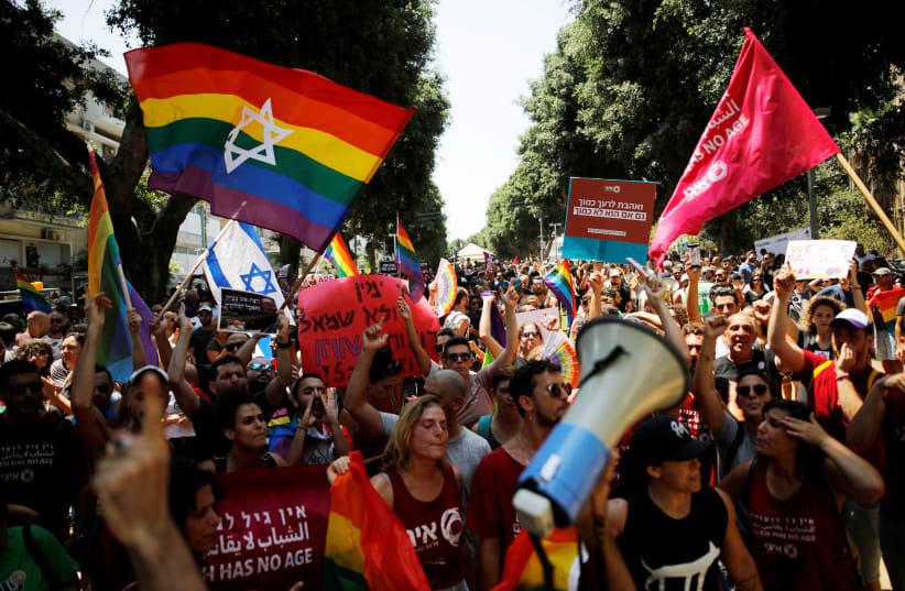 Protestors shout slogans during a LGBT community members protest against discriminatory surrogate bill in Tel Aviv, Israel July 22, 2018 (photo credit: CORINNA KERN/REUTERS)
