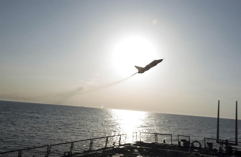 An U.S. Navy picture shows what appears to be a Russian Sukhoi SU-24 attack aircraft flying over the U.S. guided missile destroyer USS Donald Cook in the Baltic Sea in this picture taken April 12, 2016 and released April 13, 2016 (photo credit: REUTERS)