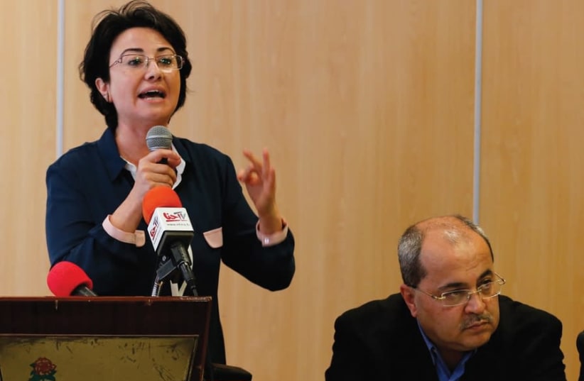 MK Haneen Zoabi [L] speaks at a news conference announcing the Joint List political slate of all the Arab parties with Ahmed Tibi [R], in Nazareth in 2015 (photo credit: AMMAR AWAD/REUTERS)