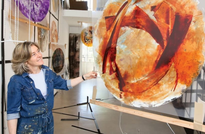 BEVERLY BARKAT looks at one of the paintings that will make up part of her new exhibition ‘After the Tribes.’ (photo credit: MARC ISRAEL SELLEM)