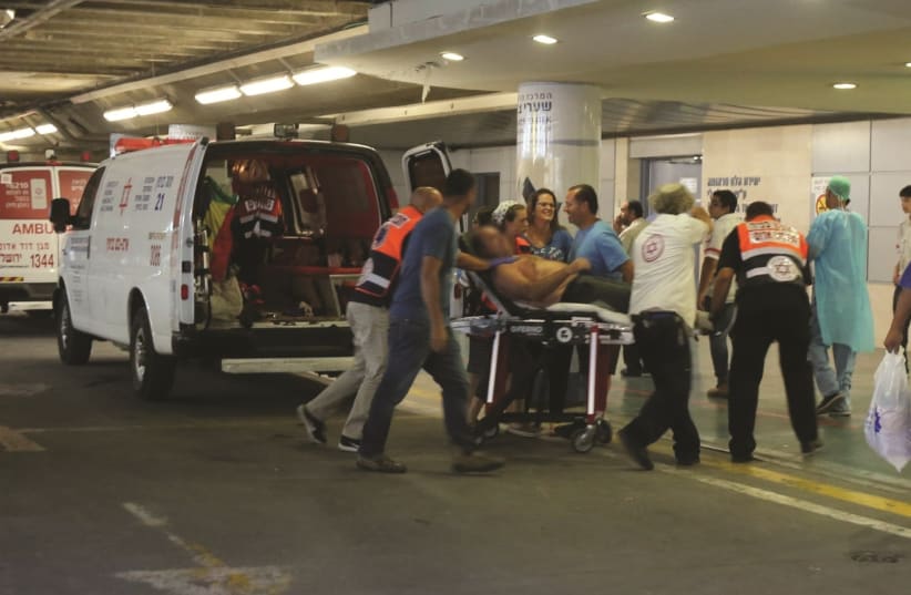 One of the victims of the stabbing attack are evacuated to Shaare Zedek Medical Center, July 26, 2018. (photo credit: MARC ISRAEL SELLEM)