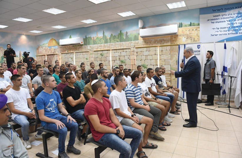 PRIME MINISTER Benjamin Netanyahu meets with new IDF and Border Police recruits yesterday.  (photo credit: HAIM ZACH/GPO)