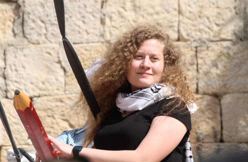 Ahed Tamimi next to a large Palestinian monument  (photo credit: TOVAH LAZAROFF)