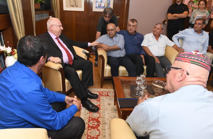 PRESIDENT REUVEN RIVLIN with Rafik Halabi (seated, at Rivlin’s left) and other Druze leaders (photo credit: MARK NEYMAN / GPO)