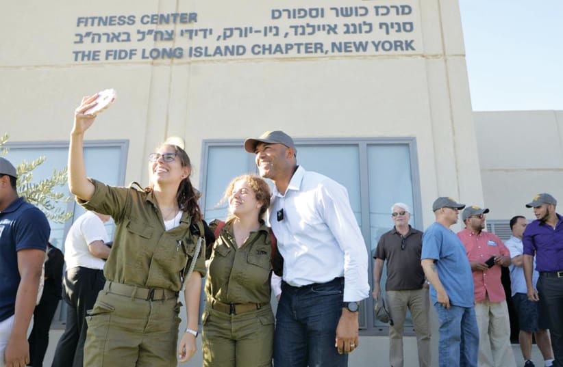 A COUPLE of Israeli soldiers take a selfie with baseball legend Mariano Rivera during his visit this week to the Michve Alon IDF base in Northern Israel. (photo credit: REUTERS)