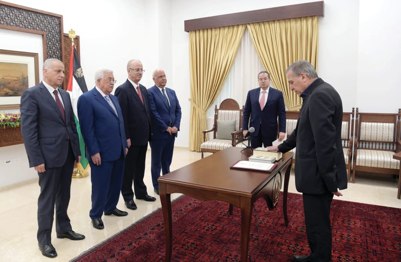 PALESTINIAN DEPUTY PRIME MINISTER Nabil Abu Rudeineh is sworn in before President Mahmoud Abbas in Ramallah (photo credit: PALESTINIAN PRESIDENT OFFICE VIA REUTERS)