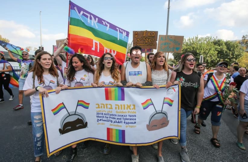 MARCHERS TAKE part in the Jerusalem Pride Parade this past Sunday, as a sign in the background proclaims ‘I have no other land' (photo credit: MARC ISRAEL SELLEM)