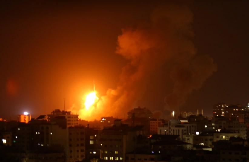An explosion is seen during an Israeli air strike in Gaza City August 8, 2018.  (photo credit: STRINGER/ REUTERS)