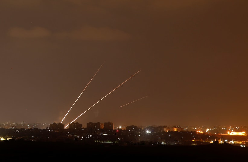 Streaks of light are pictured as rockets are launched from the northern Gaza Strip towards Israel, as seen from Sderot, Israel August 8, 2018.  (photo credit: AMIR COHEN - REUTERS)
