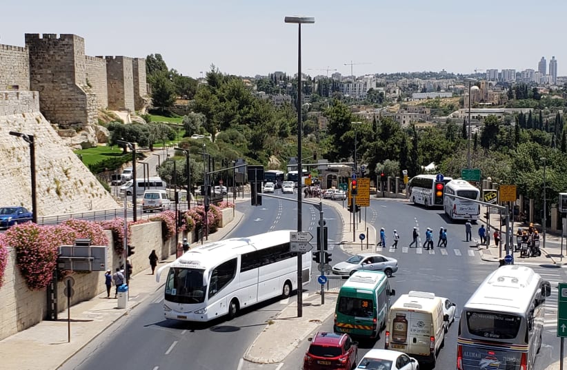  A view of Jerusalem's Old City walls near Jaffa Gate, with a tour bus in the center, August 9 2018 (photo credit: OREN OPPENHEIM)