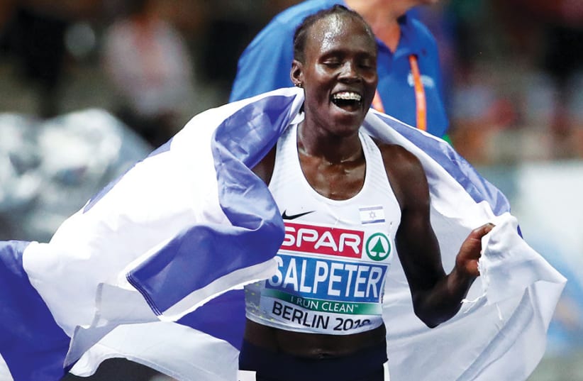 Lonah Chemtai Salpeter of Israel celebrates after winning a gold medal in the 10,000 meters at the European Championships in Berlin (photo credit: REUTERS)