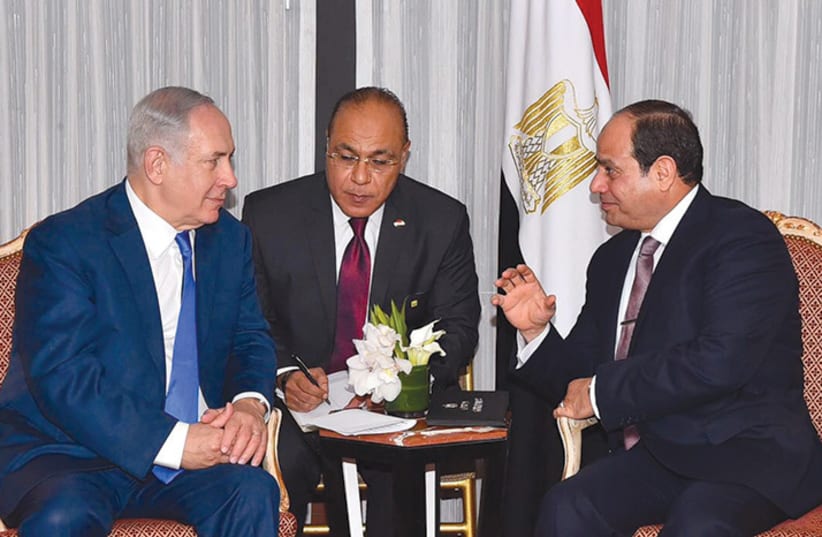 Egyptian President Abdel Fattah al-Sisi (right) speaks with Prime Minister Benjamin Netanyahu during their meeting ahead of the UN General Assembly last September (2017). (photo credit: REUTERS)