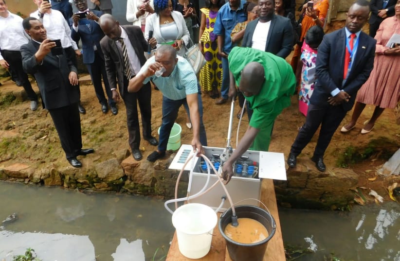 A demonstration of the NUF purification system in Cameroon to government officials, local journalists and representatives from Israel (photo credit: Courtesy)