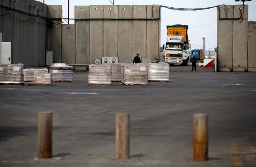 A truck parks next to a security barrier inside the Kerem Shalom border crossing terminal between Israel and Gaza Strip January 16, 2018 (photo credit: AMIR COHEN/REUTERS)
