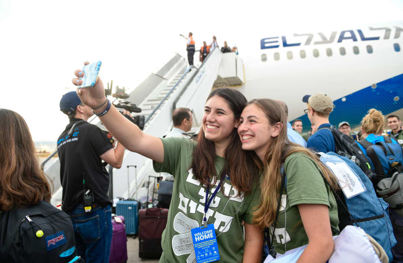 Two new Olim taking an excited selfie upon landing in Israel (photo credit: SHAHAR AZRAN)