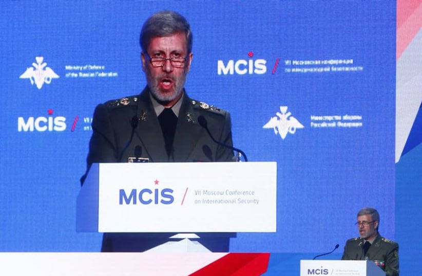 Iranian Defense Minister Amir Hatami delivers a speech during the annual Moscow Conference on International Security (MCIS) in Moscow, Russia April 4, 2018 (photo credit: REUTERS/SERGEI KARPUKHIN)