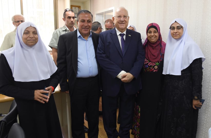 President Reuven Rivlin next to the mayor of Kafr Qasim Adel Badir alongside members of the Kafr Qasim Council of Women (photo credit: MARC NEYMAN/GPO)