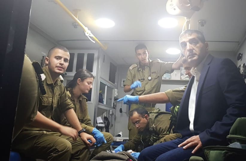 SHEBA MEDICAL CENTER Director General, Prof. Yitshak Kreiss and IDF combat medics transport a severely wounded Syrian child to Sheba Medical Center. (photo credit: COURTESY - SHEBA MEDICAL CENTER)
