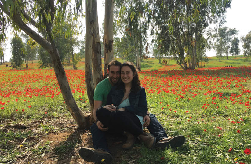 THE WRITER’S daughter Merav and husband, Gabe, at the Darom Adom festival in February – about a month before the protests along the Gaza border started. Today, where the picture captured the beautiful red anemones, it’s all burned fields because of the fire kites. (photo credit: BRIAN BLUM)