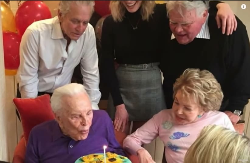 Kirk Douglas on his 101'th Birthday with family members around him  (photo credit: YOUTUBE SCREENSHOT)