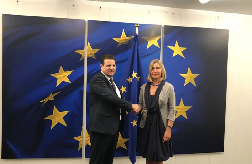 Ayman Odeh shakes hands with Federica Mogherini in Brussles, September 4, 2019 (photo credit: JOINT LIST)
